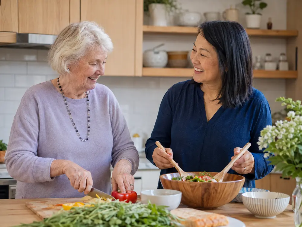 Caregiver and older adult preparing a meal together at home